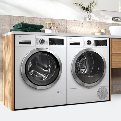 Washer and dryer in a bathroom standing side by side